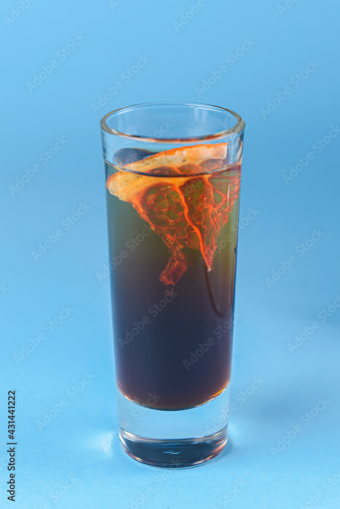 Fruit citrus apple cocktail over blue background. Alcoholic beverages served in unique glasses over blue. Fruit citrus apple cocktail over blue background. Alcoholic beverages served in unique glasses over blue.
