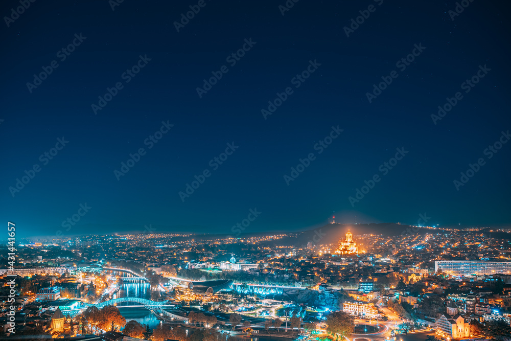 Tbilisi, Georgia. Elevated Rooftop View Of Famous Landmarks In Night Illuminations. Georgian Capital Skyline Cityscape. Night City Center