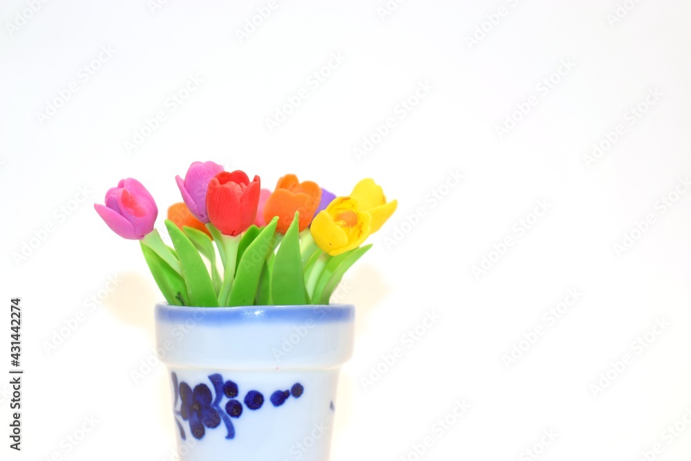 miniature bouquet of flowers in a white clay pot