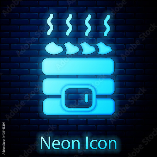 Glowing neon Hot sauna stones icon isolated on brick wall background. Spa resort recreation, bathhouse relaxation. Hot stones on electric heater. Vector
