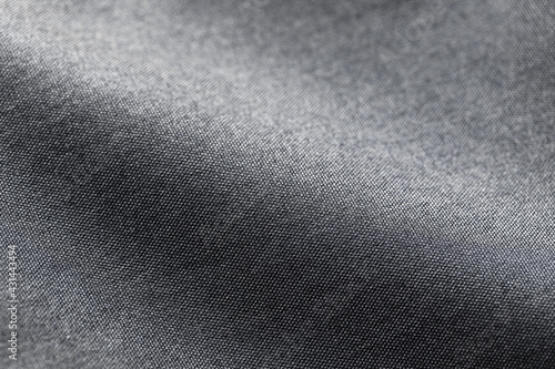 Canvas Polyester texture synthetical for background. Black polyester fabric textile backdrop for interior art design or add text message. © pattanawit