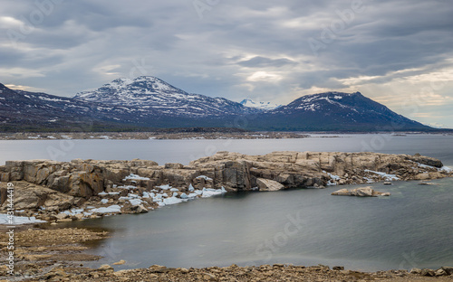 Landscape with the reservoir Akkajaure and mountains in Sarek National Park under overcast sky, Lapland, Sweden. photo