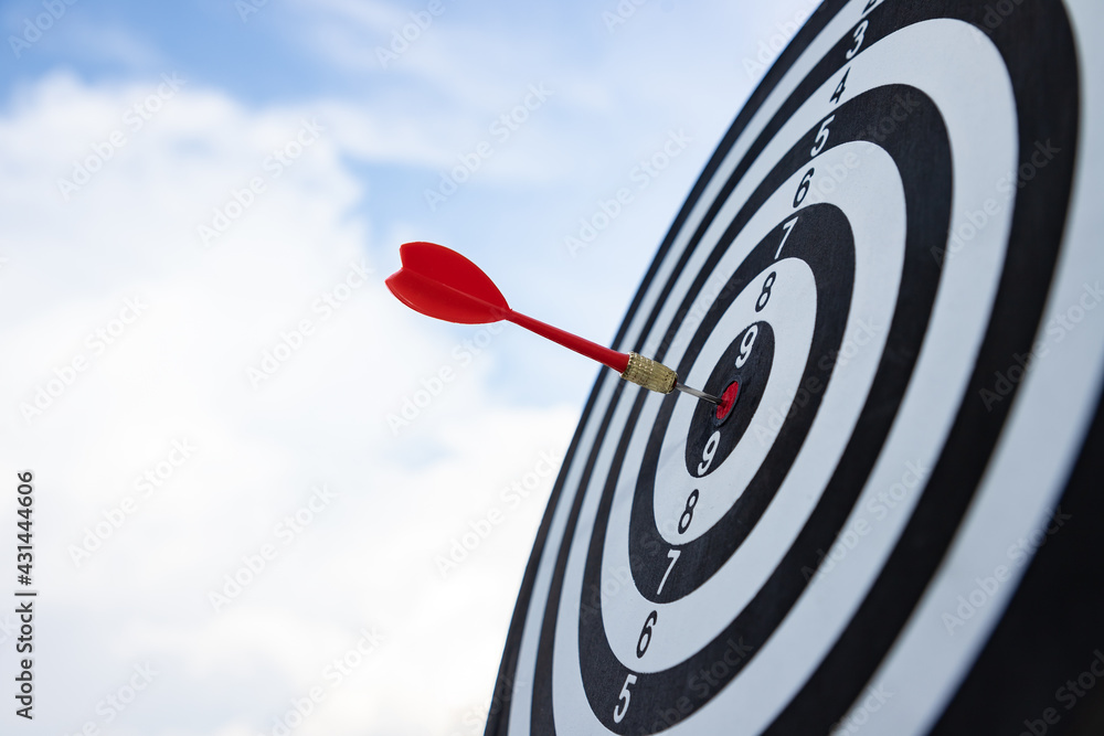 Red dart target arrow hitting on bullseye with blue sky. Dreaming for target marketing and business success concept. Scoreboard defining clear goals. Red dart target arrow hitting on bullseye with blue sky. Dreaming for target marketing and business success concept. Scoreboard defining clear goals.