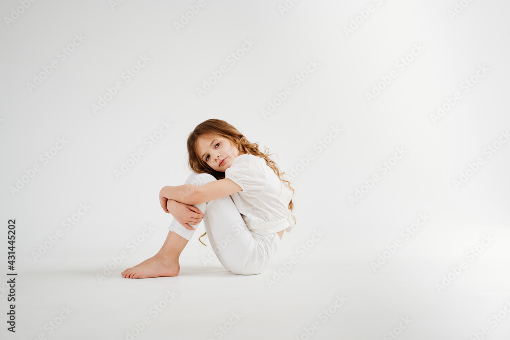 barefoot little girl with long hair in white clothes.shampoo for children's hair barefoot little girl with long hair in white clothes.shampoo for children's hair