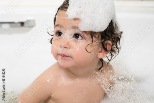 baby girl in the bathtub with foam