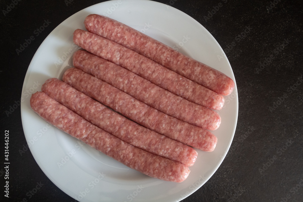 Raw sausages on a plate Raw sausages on a plate