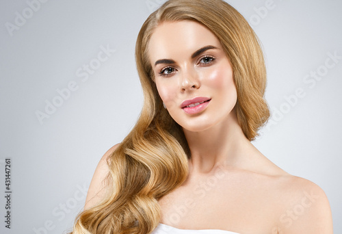 Beautiful blonde hair woman with healthy hair and skin over gray background, beauty young model with cute face and lips eyes beauty