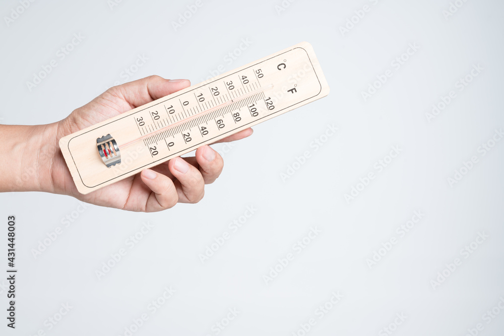 Hand holding classic thermometer for checking temperature Hand holding classic thermometer for checking temperature