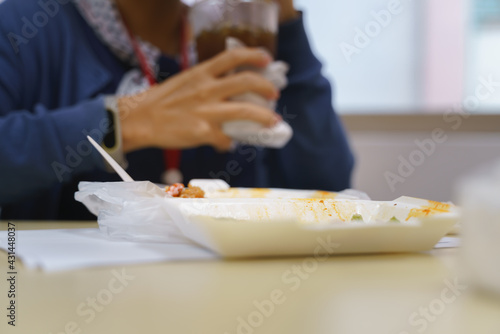 Woman in office uniform eating Thai food