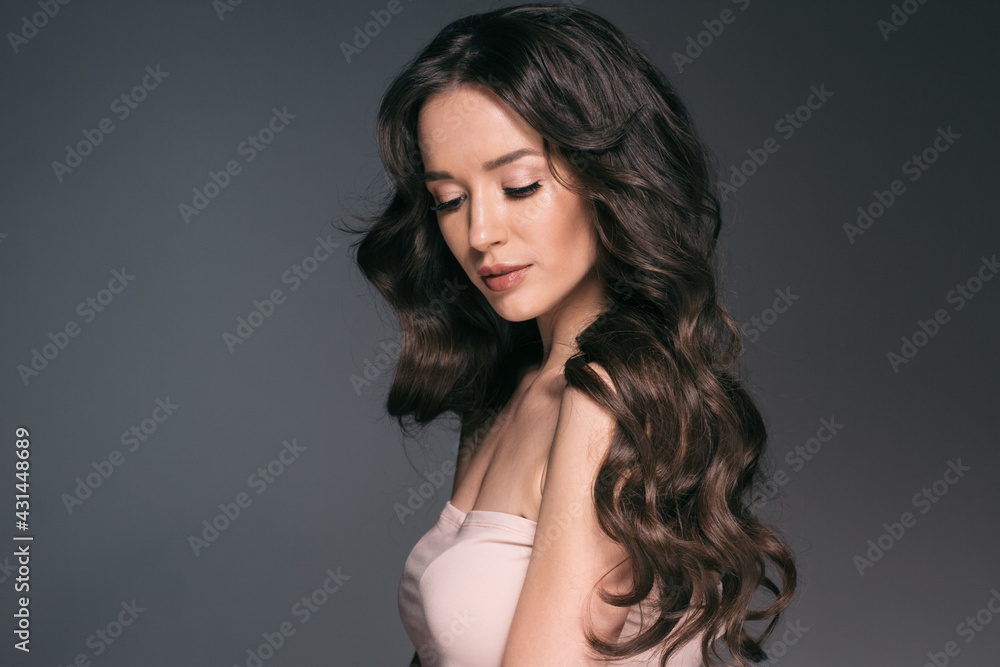 Beautiful woman with long hair, shine and curly, beauty girl female over darl gray background Beautiful woman with long hair, shine and curly, beauty girl female over darl gray background