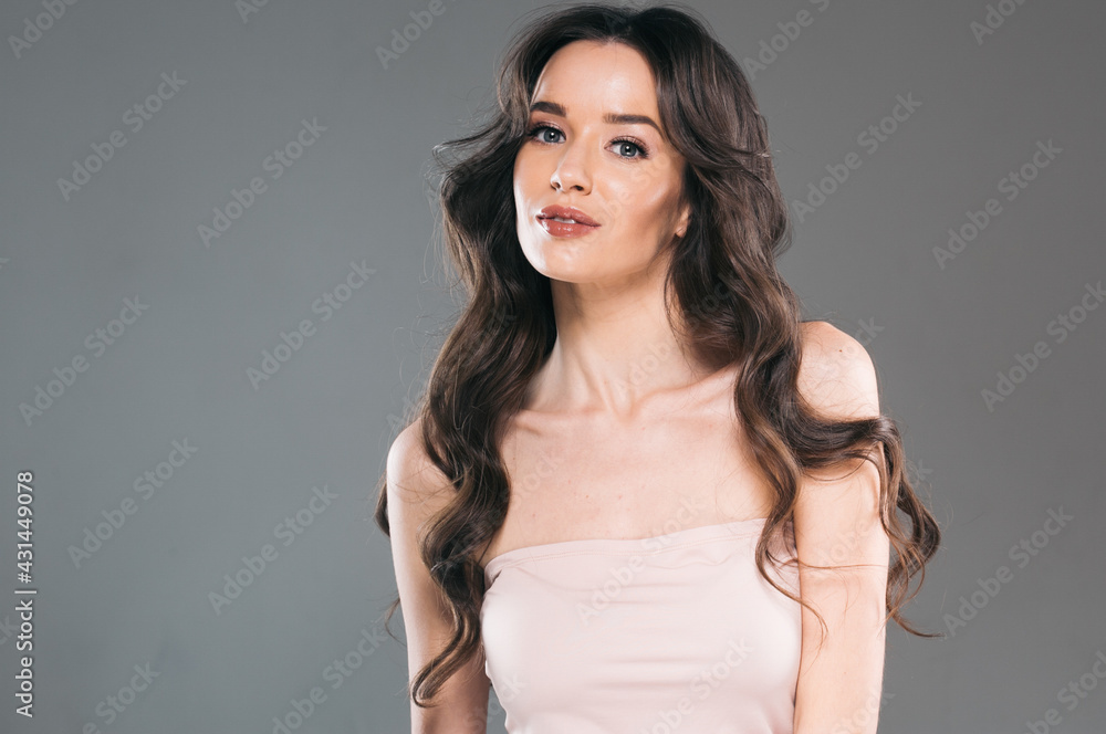 Beautiful woman with long hair, shine and curly, beauty girl female over darl gray background Beautiful woman with long hair, shine and curly, beauty girl female over darl gray background