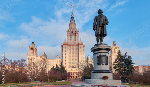 Pink peony flowers in spring campus of famous Moscow university under cloudy sky