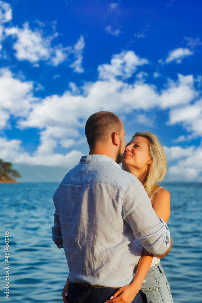 Loving couple enjoying honeymoon on territory beach hotel with luxury view
