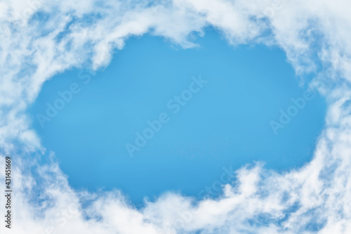 Hole of blue sky in the fluffy clouds in the sky. circle white clouds layer as frame with Blue sky background. Concept landscape, travel. Abstract and pastel color.