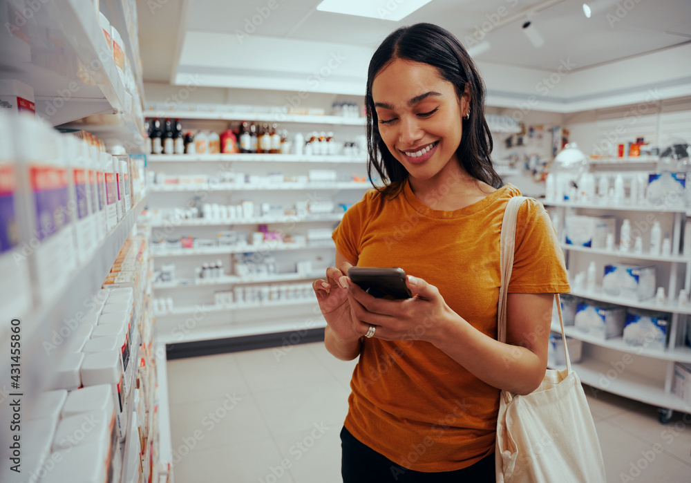 © StratfordProductions - Young woman smiling while using smartphone standing against shelf in pharmacy © StratfordProductions - Young woman smiling while using smartphone standing against shelf in pharmacy