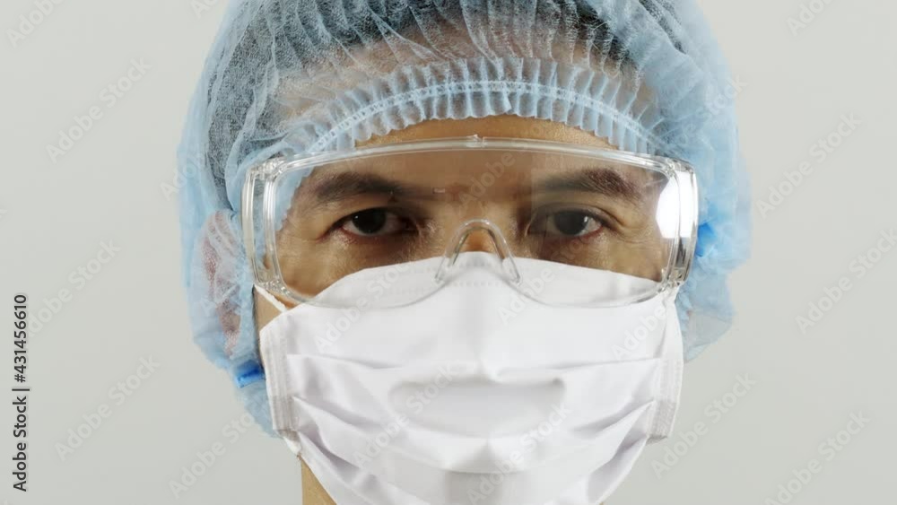 Close up Asian Doctor wear masks to prevent COVID-19 outbreak and wear protective goggles. Prepare for the reception of the sick Currently, medical personnel work hard, colona virus concept. Close up Asian Doctor wear masks to prevent COVID-19 outbreak and wear protective goggles. Prepare for the reception of the sick Currently, medical personnel work hard, colona virus concept.