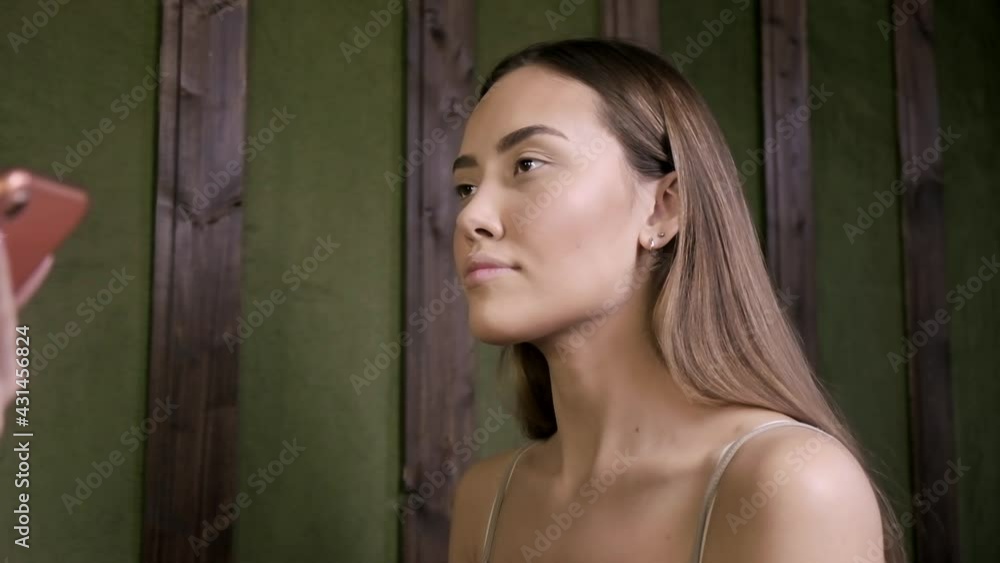 closeup portrait of young attractive brunette asian woman with perfect skin, braces on her teeth, ring on her finger sitting indoors, looking forward closeup portrait of young attractive brunette asian woman with perfect skin, braces on her teeth, ring on her finger sitting indoors, looking forward