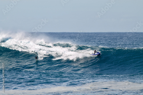 Valokuvatapetti Australian surfer towed by a jetski descending a gigantic wave between the beaches of Bondi and Maroubra south of Sydney Australia