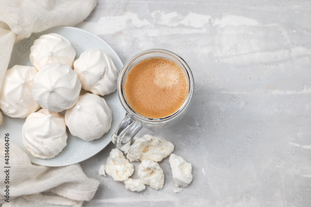 cup of coffee with meringues on white dish cup of coffee with meringues on white dish