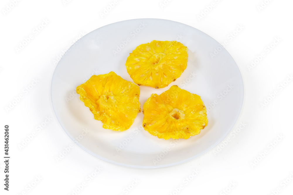 Dried pineapples slices on dish on a white background Dried pineapples slices on dish on a white background
