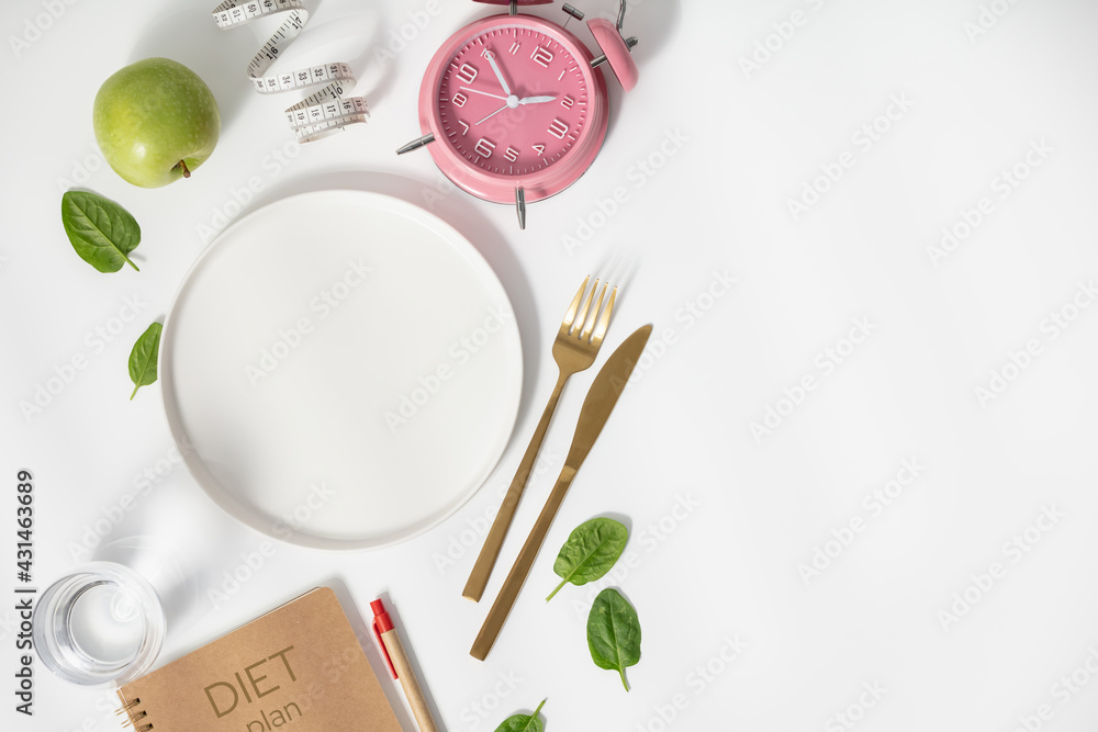 Composition with cutlery, empty plate, measuring tape, diet plan, apple and alarm clock on white background, diet concept - obrazy, fototapety, plakaty 
