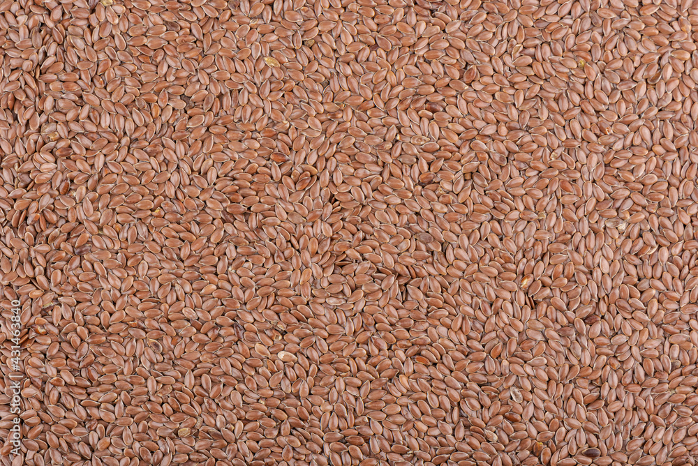 Background from a pile of natural flax seeds. Background from a pile of natural flax seeds.