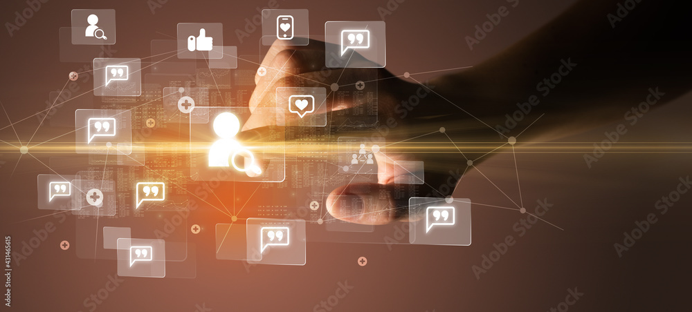 Hand pressing social media multimedia application screen with media icons on futuristic concept Hand pressing social media multimedia application screen with media icons on futuristic concept