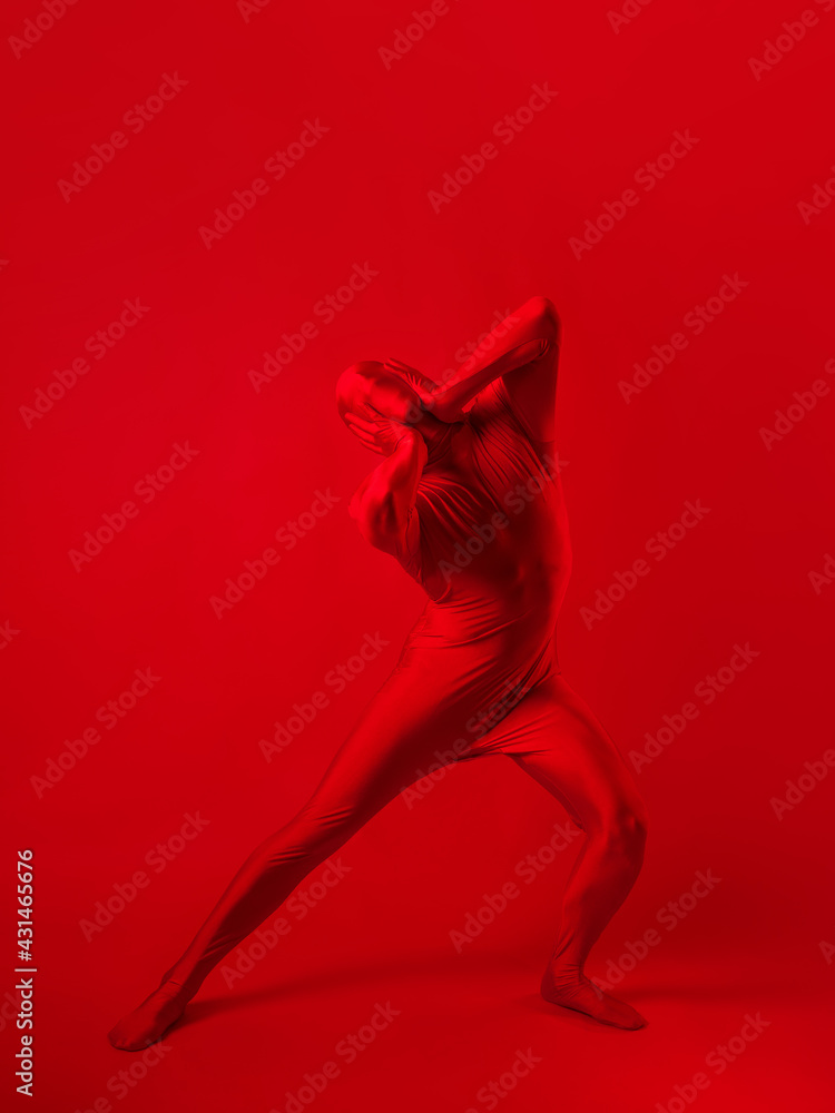 A screaming man in a red full suit, on a red background. A screaming man in a red full suit, on a red background.