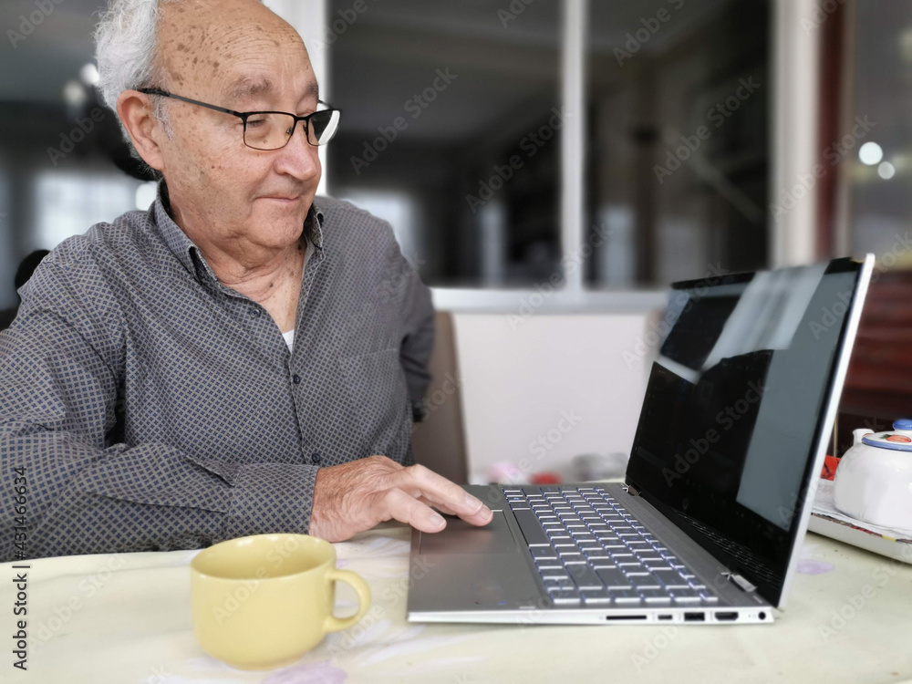 Elderly man sit on couch at home talk on video call on laptop with family friends, senior grandfather relax on sofa in living room speak communicate online use Webcam conversation Elderly man sit on couch at home talk on video call on laptop with family friends, senior grandfather relax on sofa in living room speak communicate online use Webcam conversation