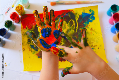 Child painting by finger hand . Ideas for drawing with finger paints. Children development . The concept of a happy childhood and children's day. photo