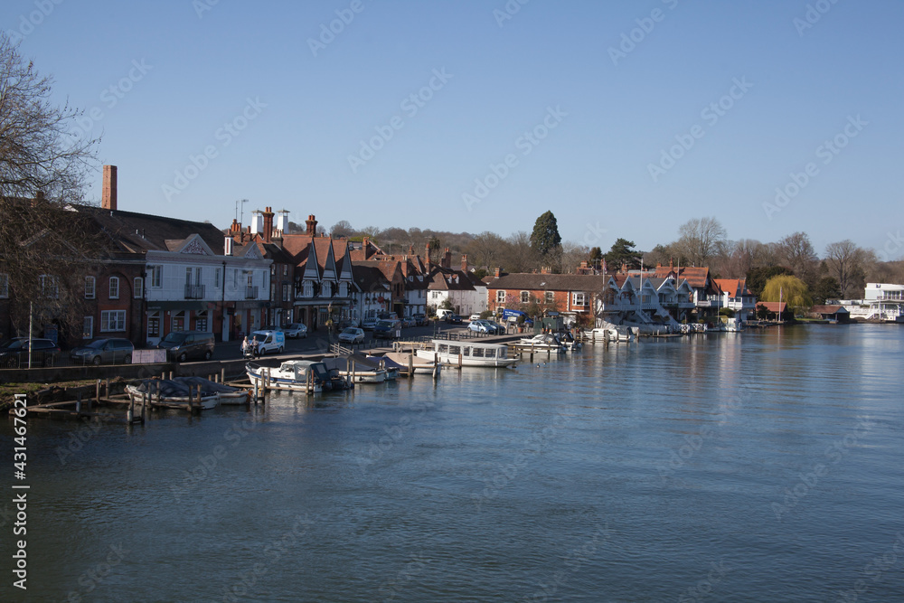 Properties and boats on The Thames in Henley on Thames in Oxfordshire in the UK