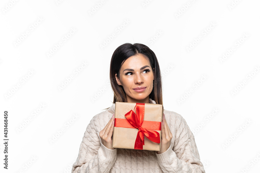 Happy pretty young woman holding gift box over gray background Happy pretty young woman holding gift box over gray background