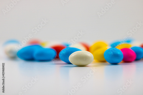 Selective focus of candies on white background.