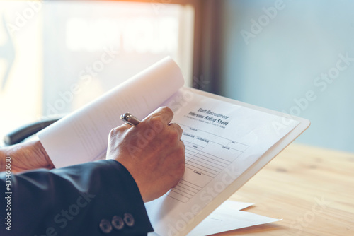 Photos Job Interview HR human resource manager interviewing new employee candidate look at CV Resume asking job requirement question at business firm office desk