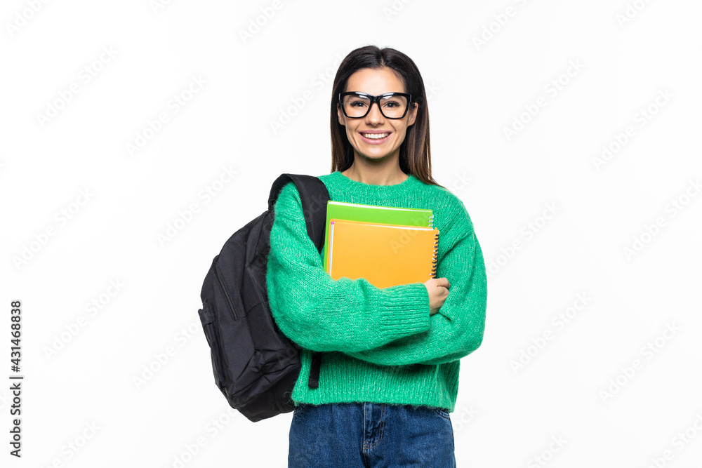 Happy young woman wearing a backpack and holding notebooks ready to go to class over white background Happy young woman wearing a backpack and holding notebooks ready to go to class over white background