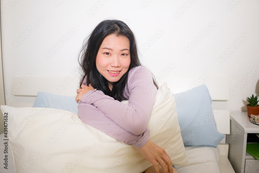 lifestyle portrait of young and beautiful Asian woman at home - attractive and happy Chinese girl looking relaxed and cheerful on bed lifestyle portrait of young and beautiful Asian woman at home - attractive and happy Chinese girl looking relaxed and cheerful on bed