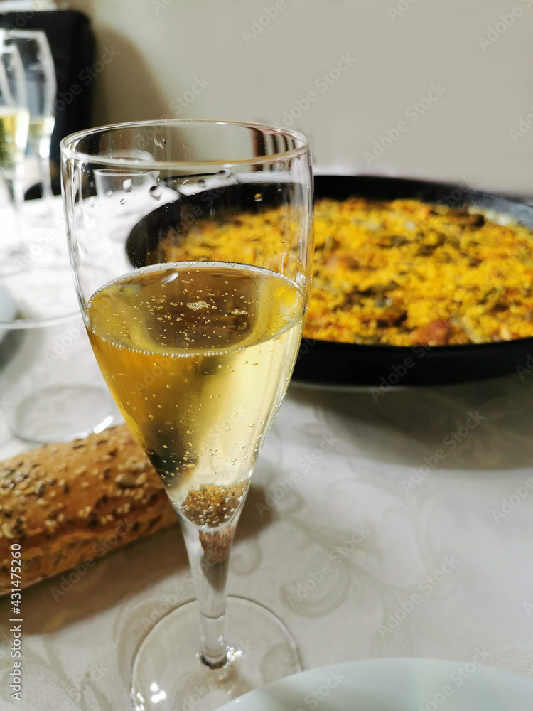 Valencian paella cooking with champagne on log fire in local Spainish village Valencian paella cooking with champagne on log fire in local Spainish village
