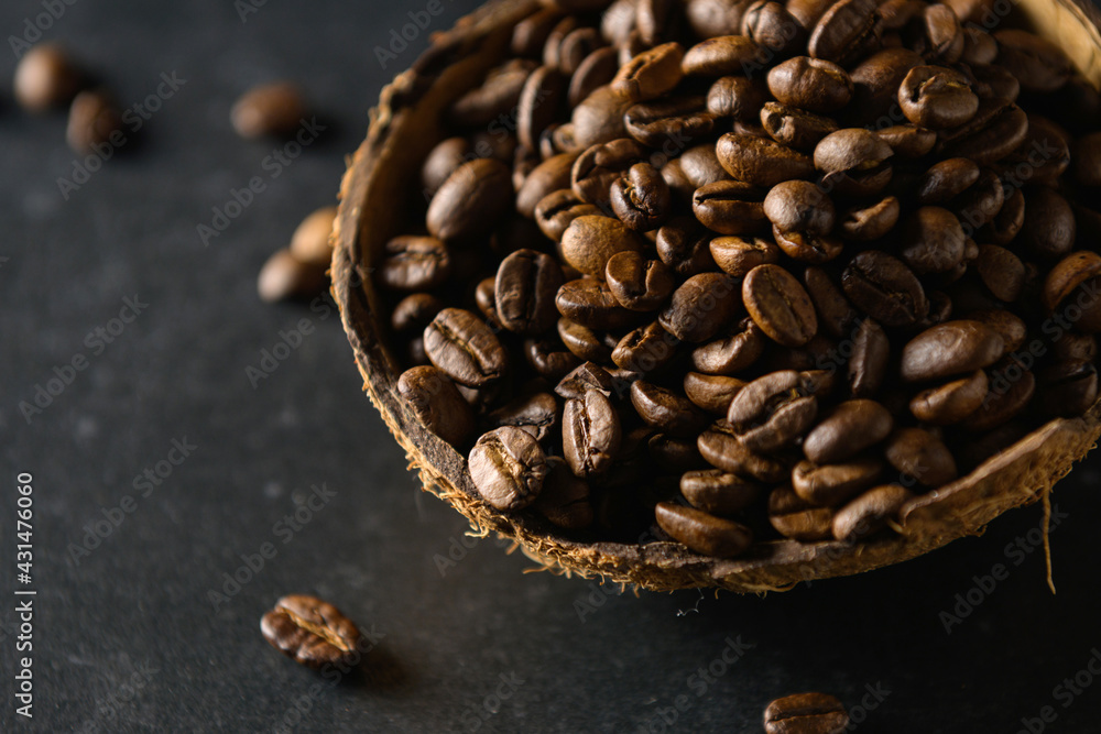 coffee beans in coconut bowl on dark gray background, close-up, coffee beans in coconut bowl on dark gray background, close-up,