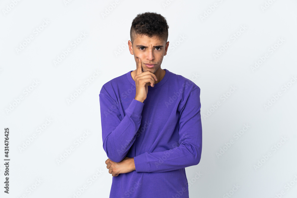 Young brazilian man isolated on white background and thinking Young brazilian man isolated on white background and thinking