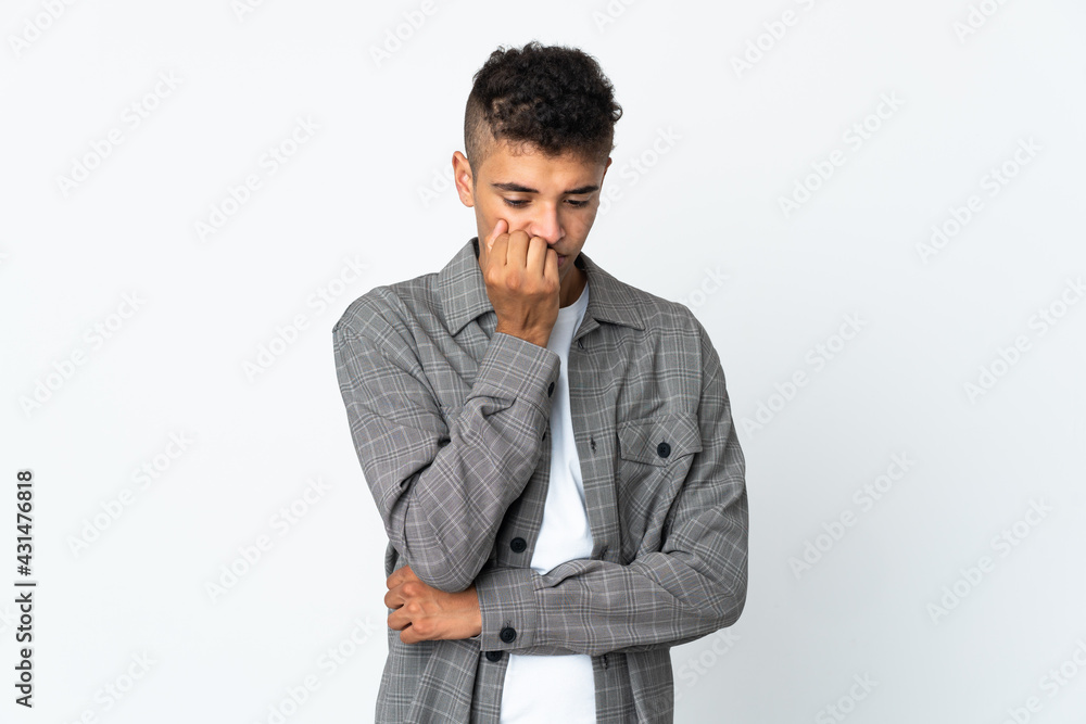 Young brazilian man isolated on white background having doubts Young brazilian man isolated on white background having doubts