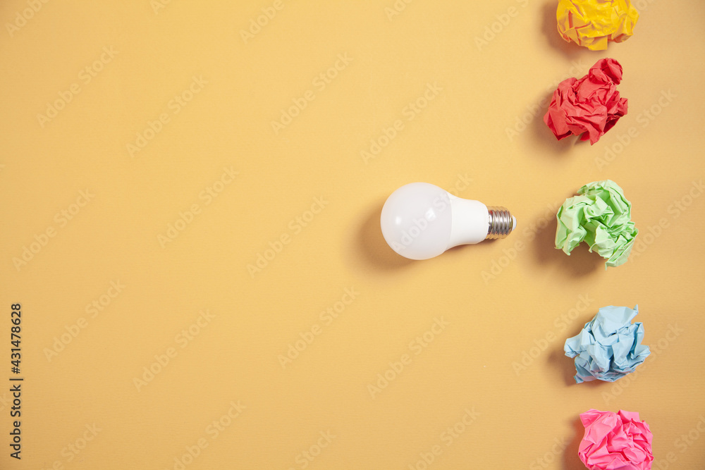 Colorful paper balls and light bulb on yellow background. Colorful paper balls and light bulb on yellow background.
