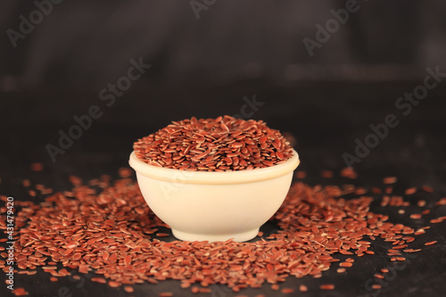 flex seeds in a white bowl with the black background,high fibre flex seed in bowl,Linum usitatissimum,Also known as Linseed photo