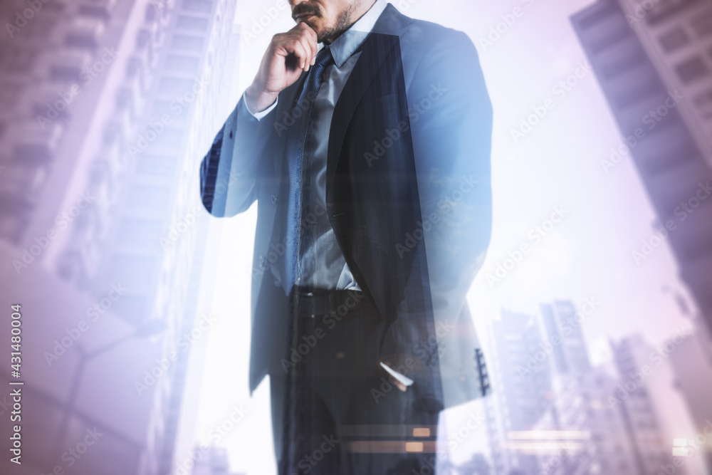 Businessman standing thinking with skyscrapers in the background, decision and entrepreneurship concept. Double exposure Businessman standing thinking with skyscrapers in the background, decision and entrepreneurship concept. Double exposure