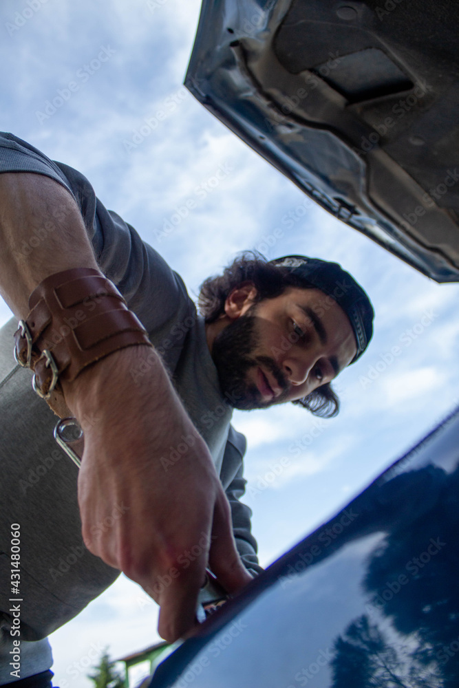person fixing a car person fixing a car