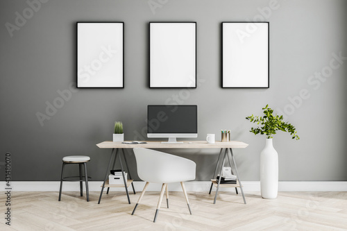 Fototapeta Naklejka Na Ścianę i Meble -  Three white blank posters on black frame on grey wall in stylish home room with classic style workspace, white vase on parquet floor. 3D rendering, mock up