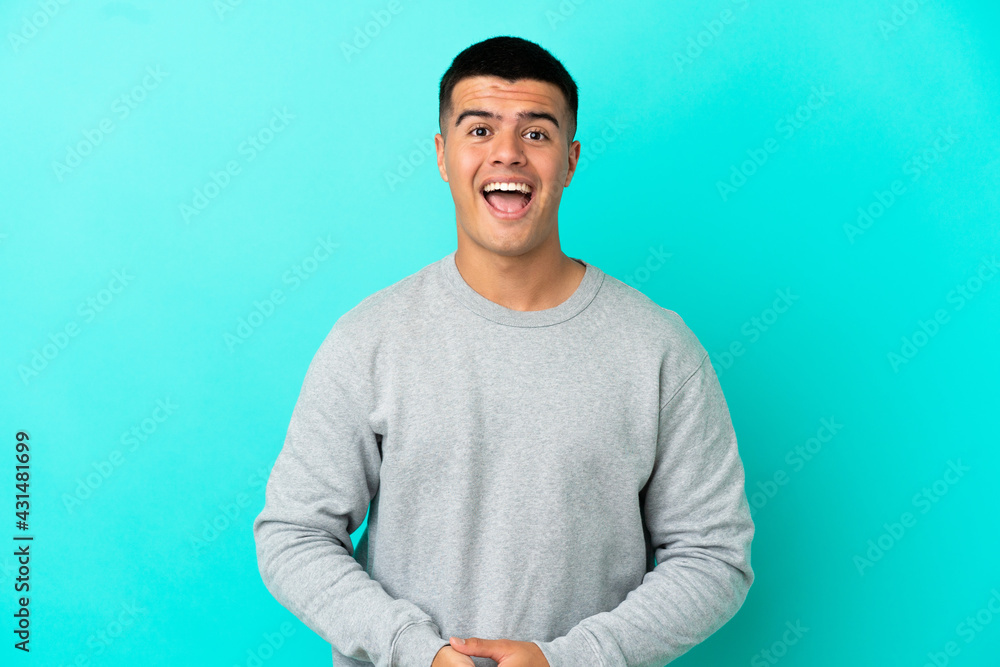Young handsome man over isolated blue background with surprise facial expression Young handsome man over isolated blue background with surprise facial expression