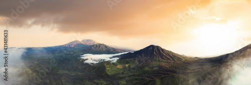 View from above, stunning panoramic view of the Ijen volcano complex during a beautiful sunrise and the turquoise acidic crater lake in the foreground. East Java, Indonesia.