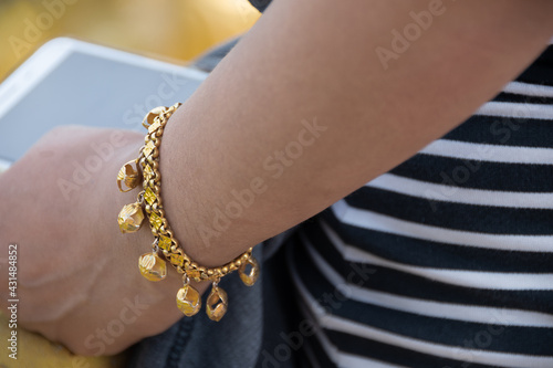 Gold bracelet. Girl wears gold bracelet in Cambodia
