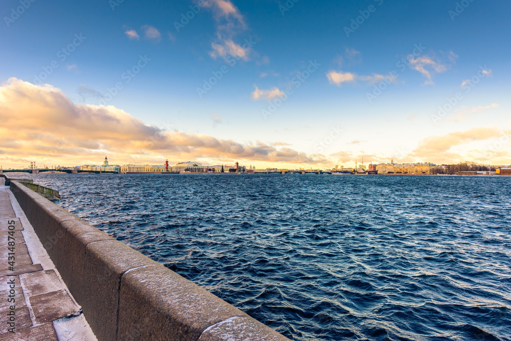 Granite quay of St. Petersburg passing along the Neva River on a winter morning. View from the waterfront