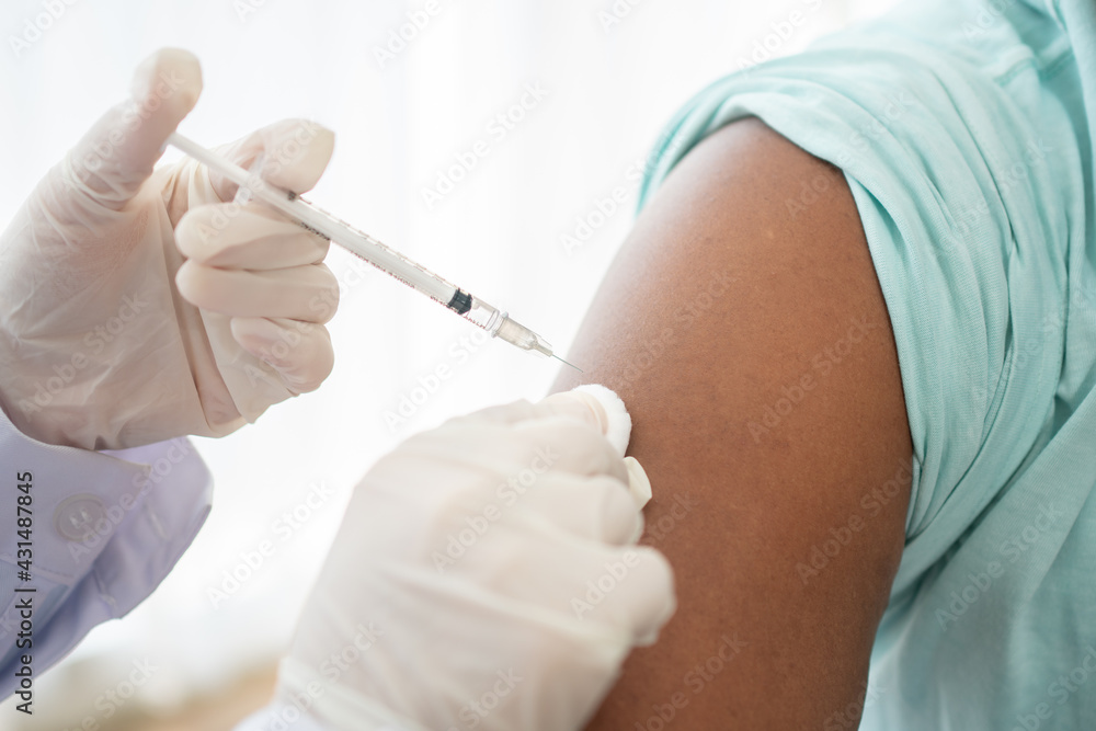 African American Wear a medical mask and being covid vaccinated for the prevention of coronavirus and flu. Concept of immunization from inoculation African American Wear a medical mask and being covid vaccinated for the prevention of coronavirus and flu. Concept of immunization from inoculation